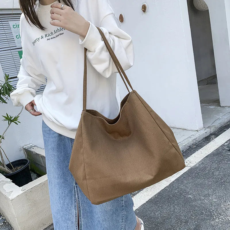 Solid colour women's canvas handbag with double shoulder straps and sandwich pocket design