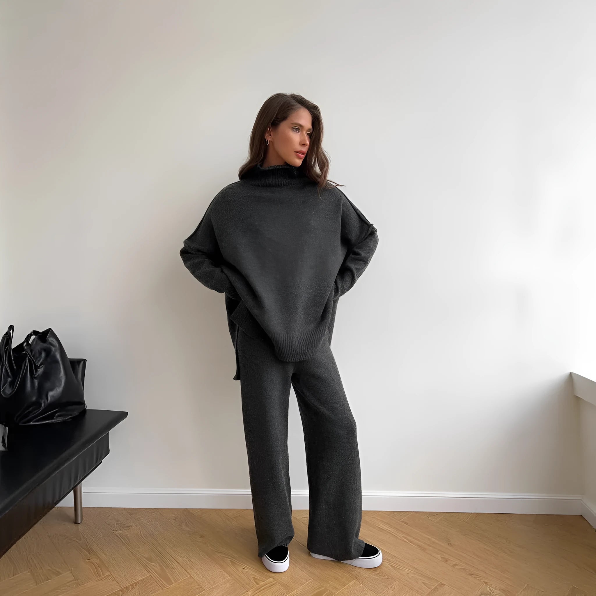Women's dark grey acrylic suit featuring a side-slit sweater with matching full-length trousers.
