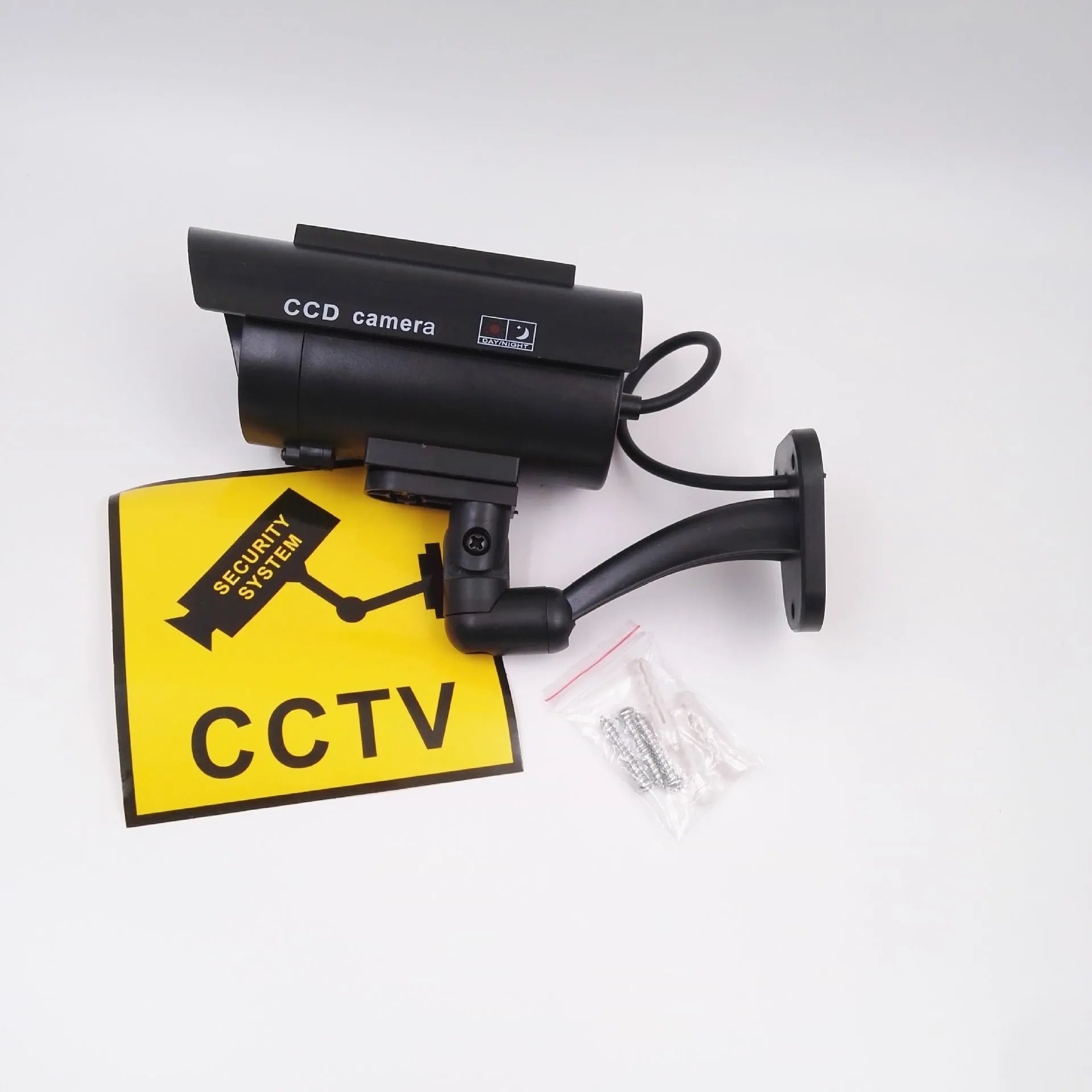 Black plastic gun-shaped dummy security camera with solar panel and red LED light indicator