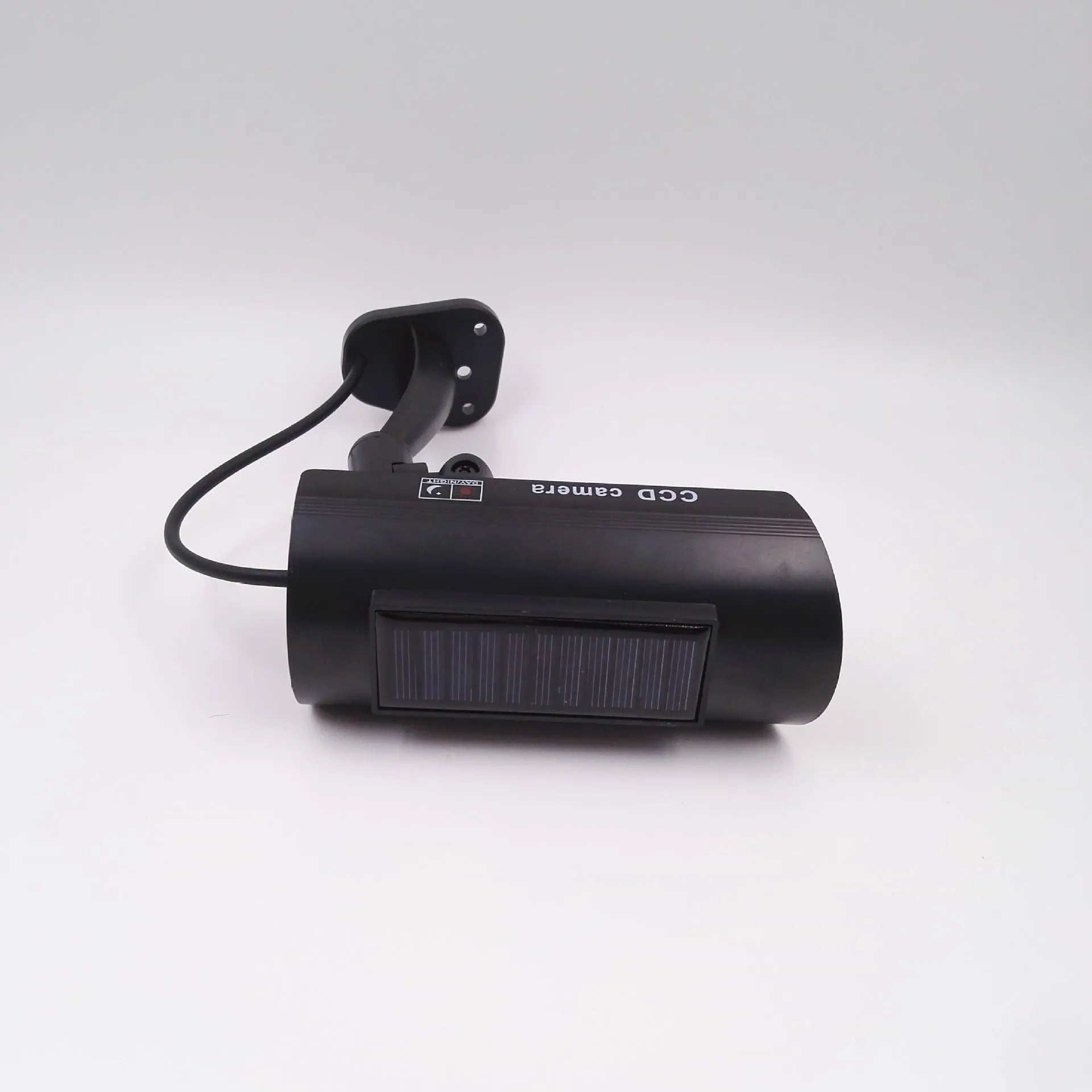Black plastic gun-shaped dummy security camera with solar panel and red LED light indicator