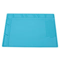 Blue silicone watch repair desk mat lying flat on a workbench.