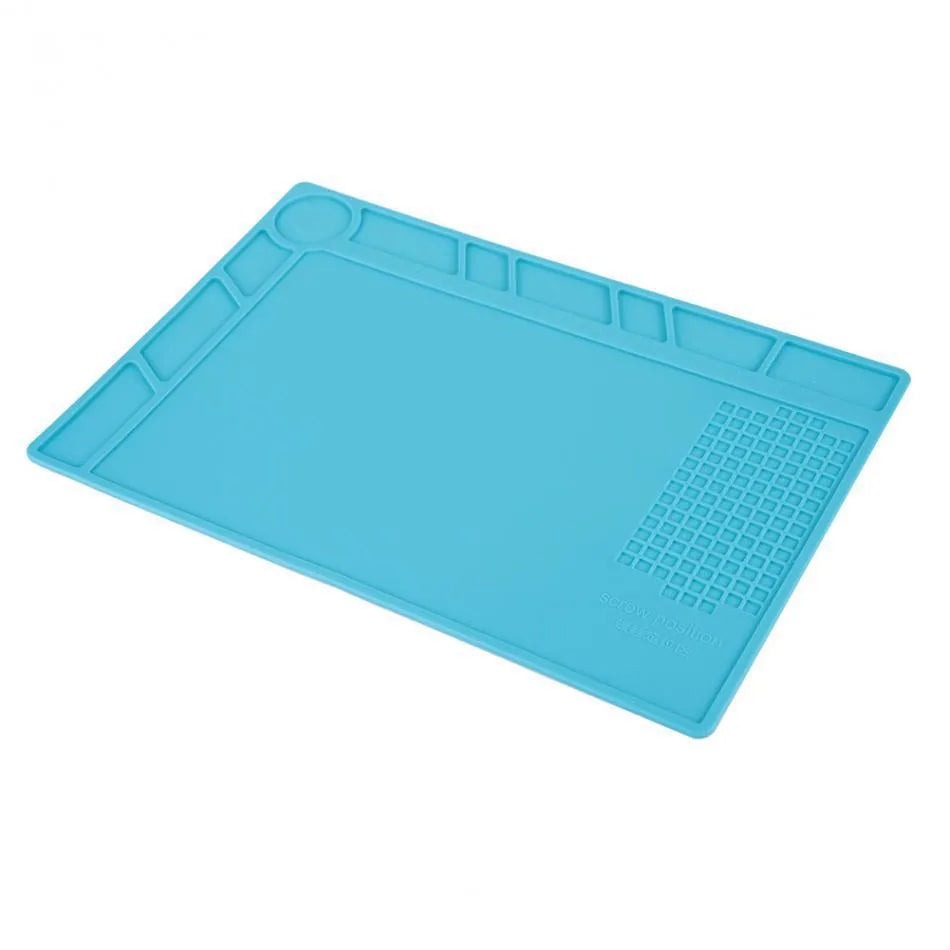 Blue silicone watch repair desk mat lying flat on a workbench.