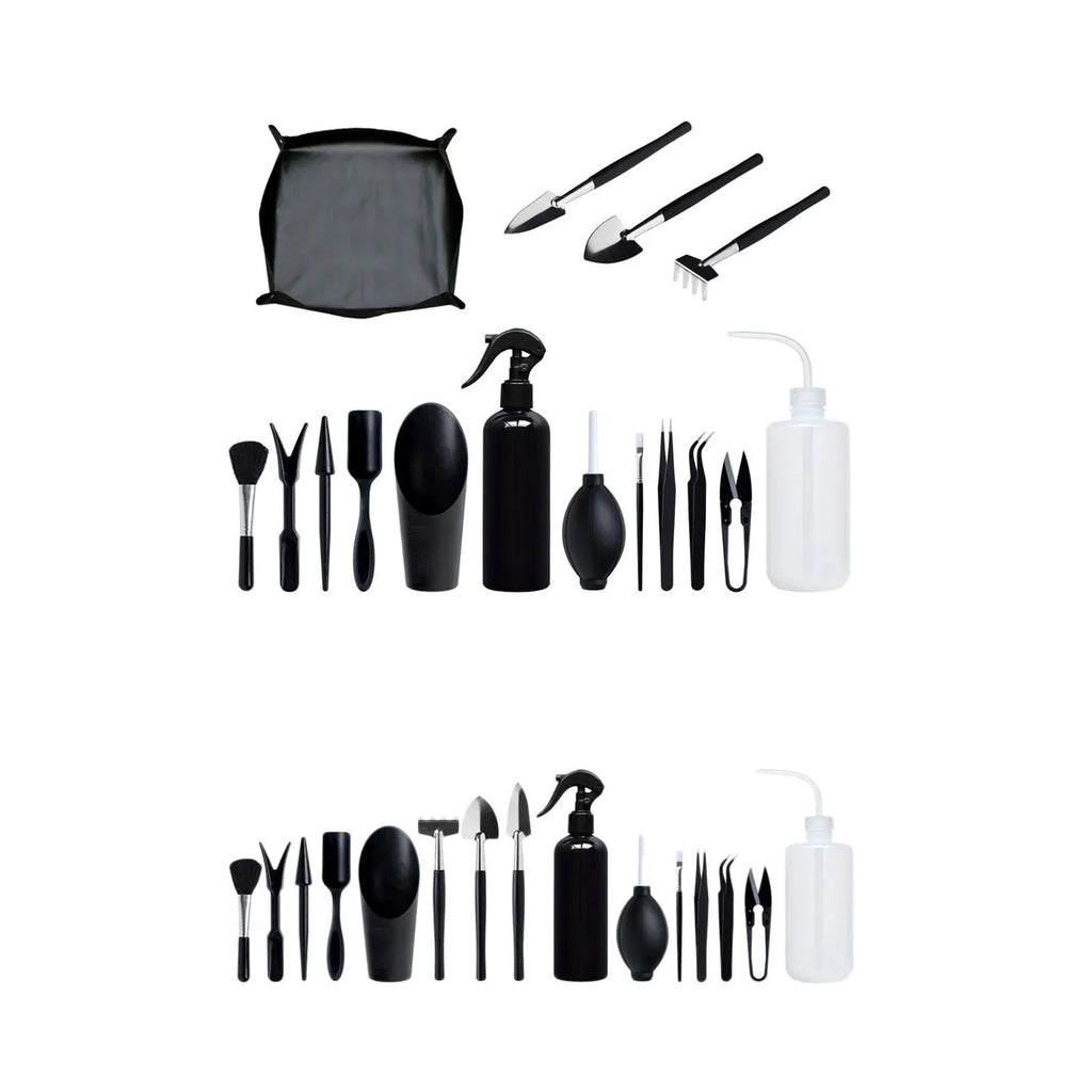 Black succulent garden tools set with shovel, tweezers, scissors, watering bottle and a square grey cushion.