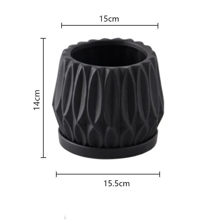 A simple grey ceramic flowerpot, medium-sized, for tabletop or floor plants.