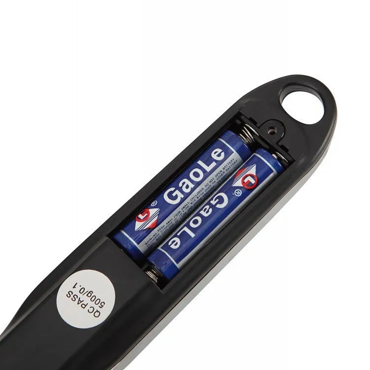 Stainless steel smart digital measuring spoon with a black LCD display showing weight measurement.