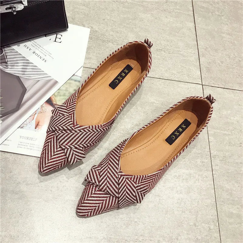 Women's pointed toe flat shoes in red with a low heel and cotton upper.