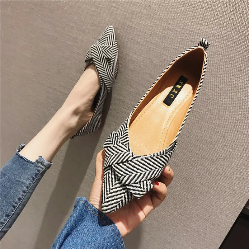 Women's pointed toe flat shoes in red with a low heel and cotton upper.