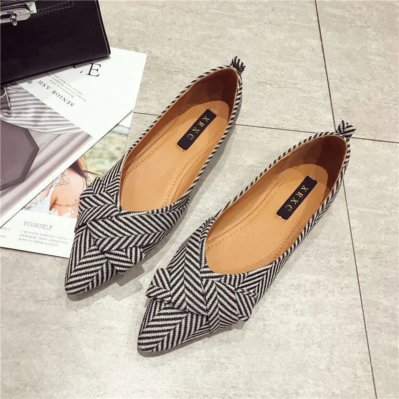 Women's pointed toe flat shoes in red with a low heel and cotton upper.