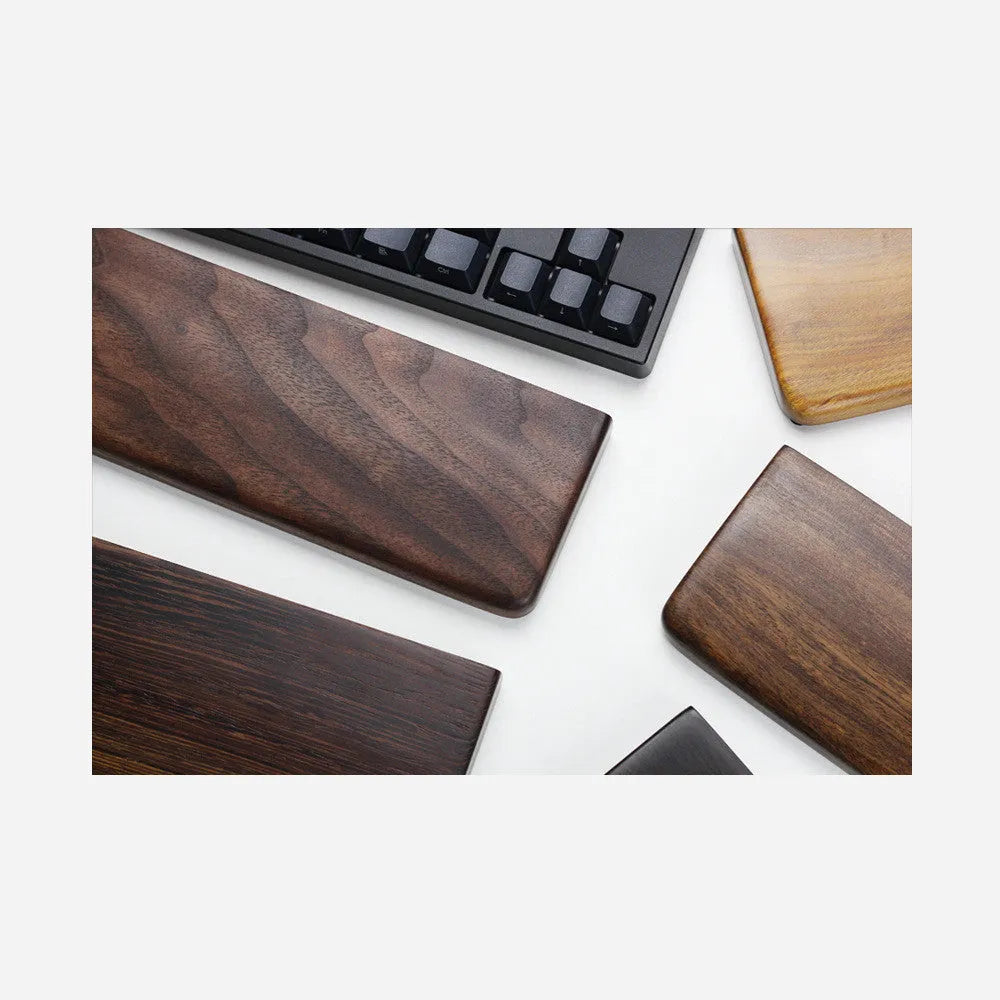 Solid black walnut wood keyboard wrist rest measuring 30cm long with curved ergonomic design