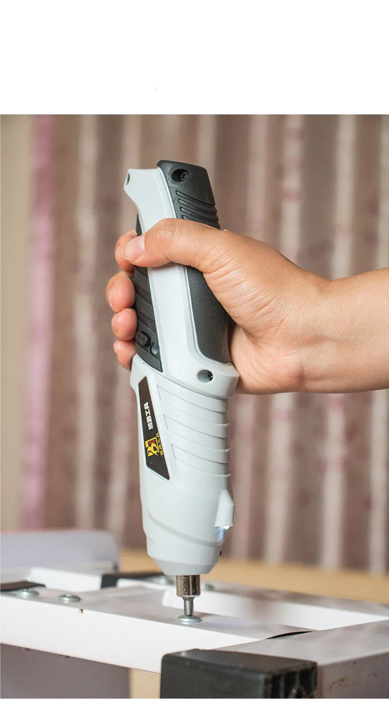 Compact black rechargeable screwdriver with pistol grip and set of driver bits for furniture assembly.