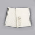 Coil-bound notebook with horizontal line and dot matrix grid pages in A5 size.