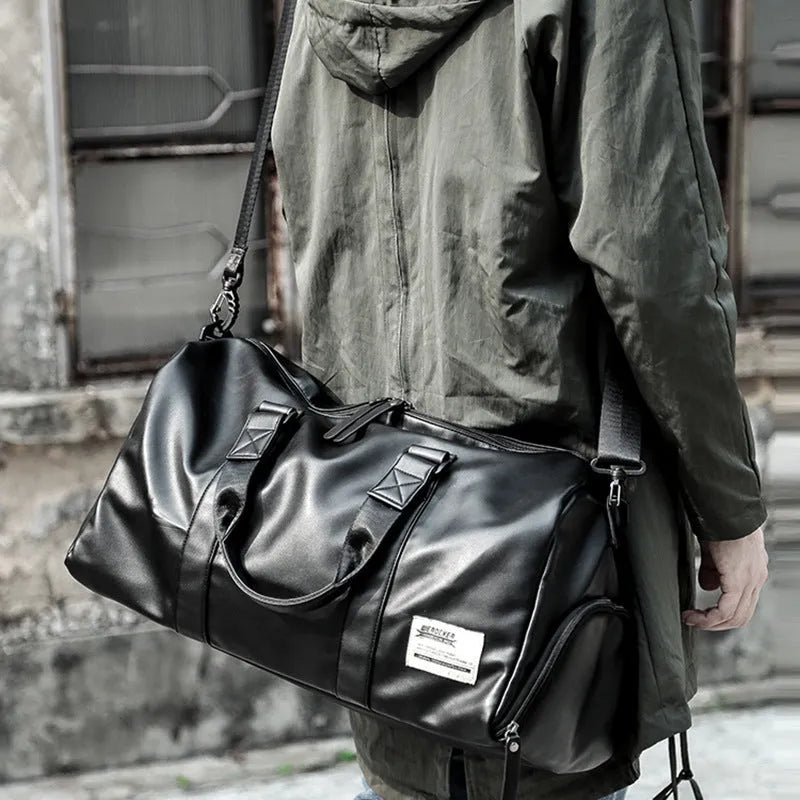 Black PU leather sports training bag showing internal organiser pockets for laptop and phone.