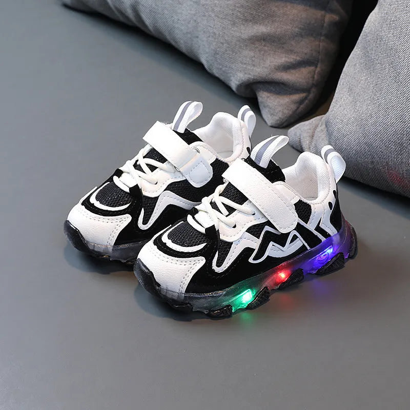 Children's black mesh Velcro sneakers with rubber sole, shown on a child's foot