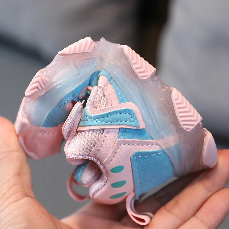 Children's black mesh Velcro sneakers with rubber sole, shown on a child's foot