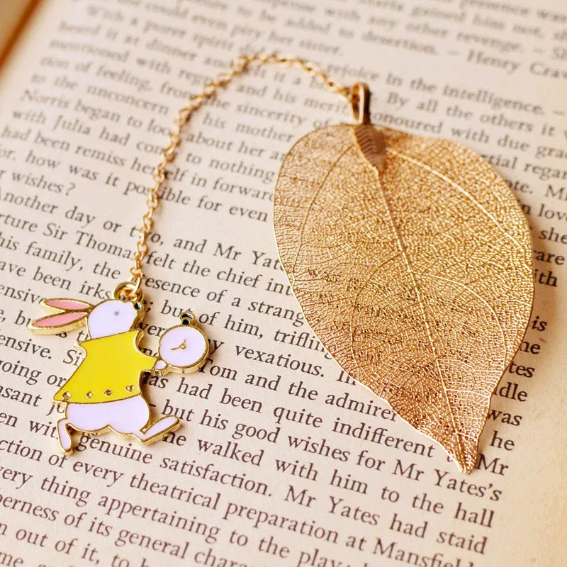 Kc alloy leaf bookmark with a choice of Alice, rabbit, or clock charm, shown with dimensions.