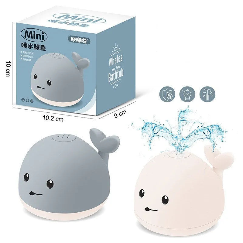 Grey and white whale bath toy with water spray, LED lights, and automatic water-sensing activation