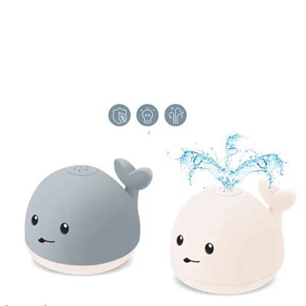 Grey and white whale bath toy with water spray, LED lights, and automatic water-sensing activation