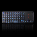 Black laser teaching mini wireless keyboard with a touch screen on a desk