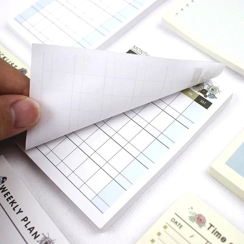 Pocket-sized weekly monthly planner notebook showing four different layout design options