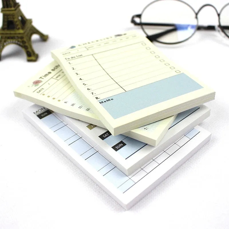 Pocket-sized weekly monthly planner notebook showing four different layout design options