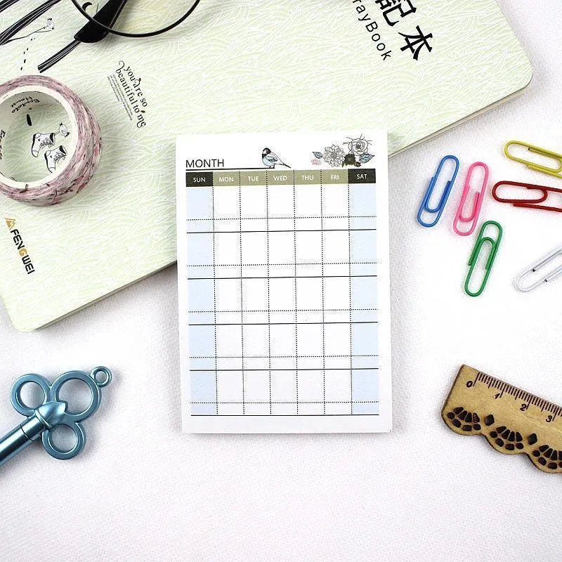 Pocket-sized weekly monthly planner notebook showing four different layout design options