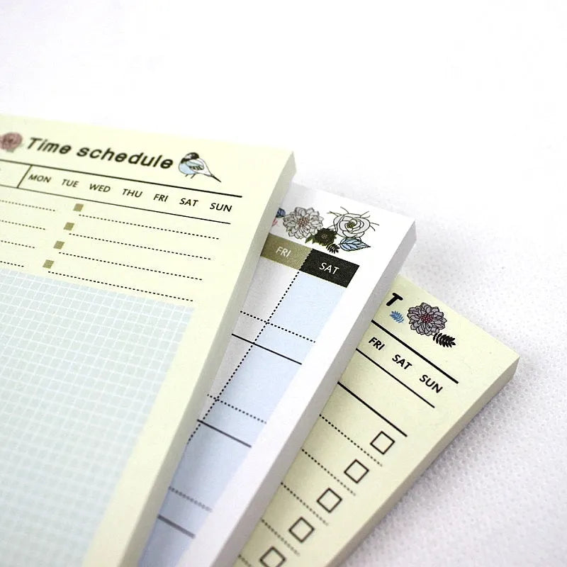 Pocket-sized weekly monthly planner notebook showing four different layout design options