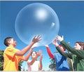 Large pink, yellow, green, and blue inflatable bouncy balls in different sizes for children's parties