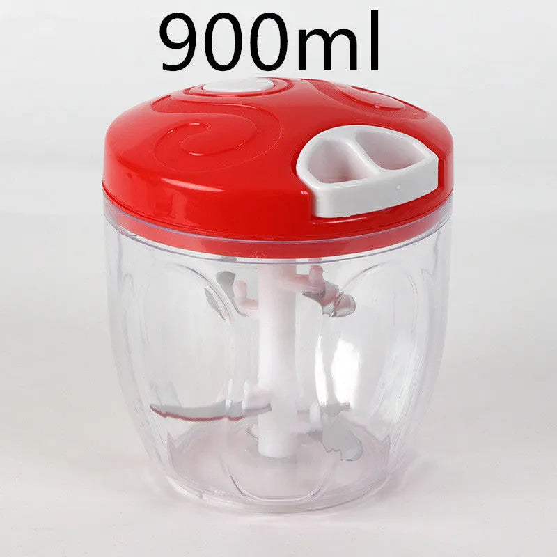 Green manual kitchen chopper with lid, showing stainless steel blades inside, on a countertop.