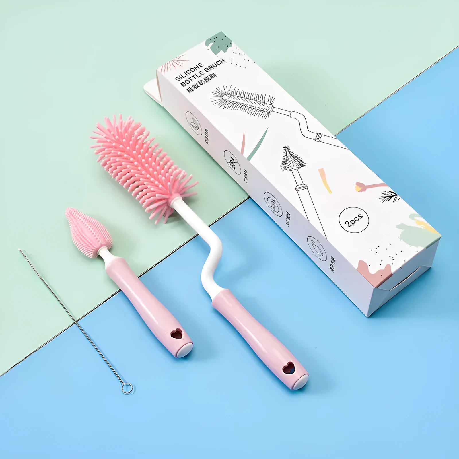 Silicone baby bottle brush cleaning set with bottle brush, straw brush, teat brush, and case in pink colour.