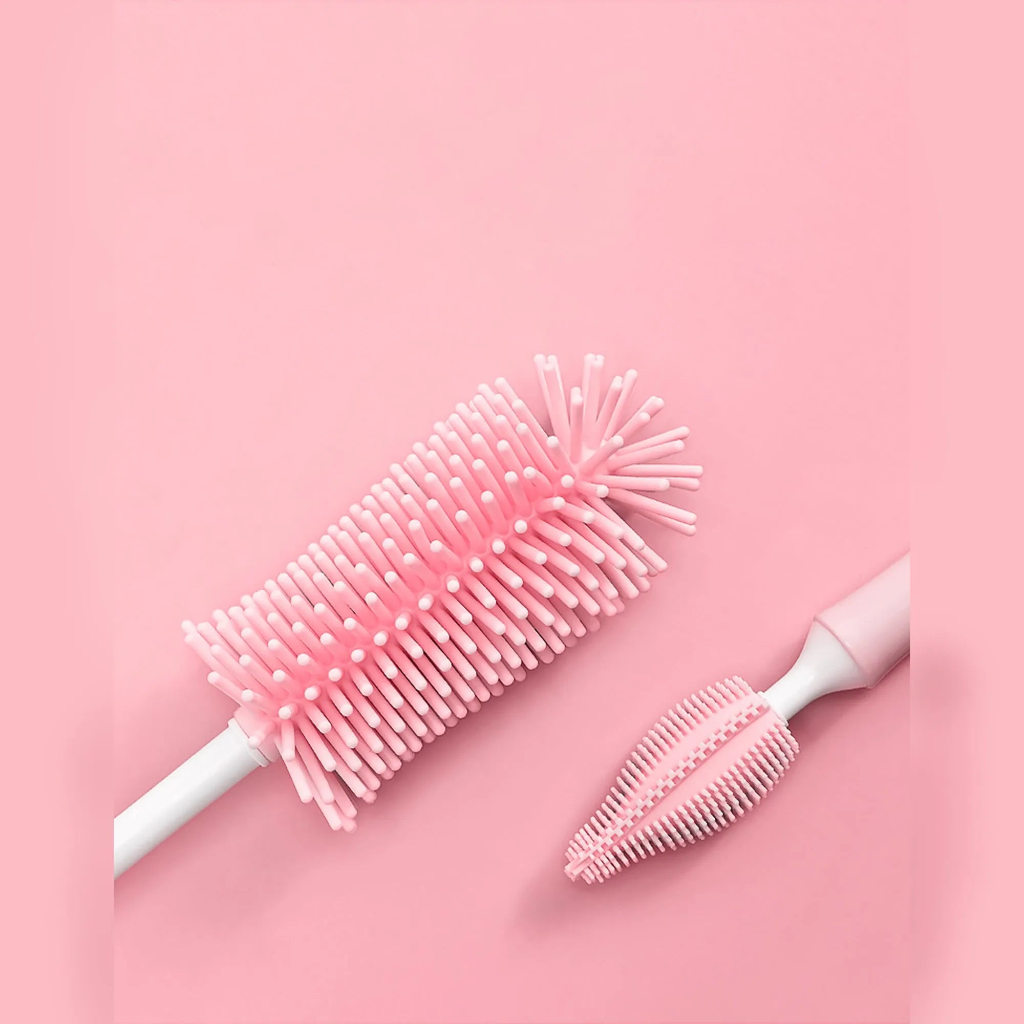 Silicone baby bottle brush cleaning set with bottle brush, straw brush, teat brush, and case in pink colour.