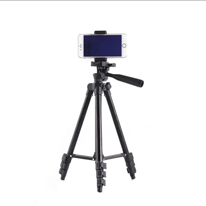 Black aluminium alloy portable tripod extended to full height with a camera mounted on its quick-release plate.