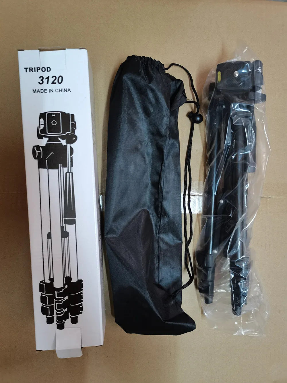 Black aluminium alloy portable tripod extended to full height with a camera mounted on its quick-release plate.