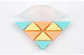 A blue PVC triangle eraser on a wooden desk next to a pencil and paper.