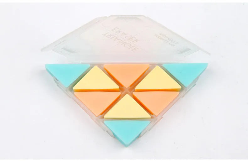 A blue PVC triangle eraser on a wooden desk next to a pencil and paper.