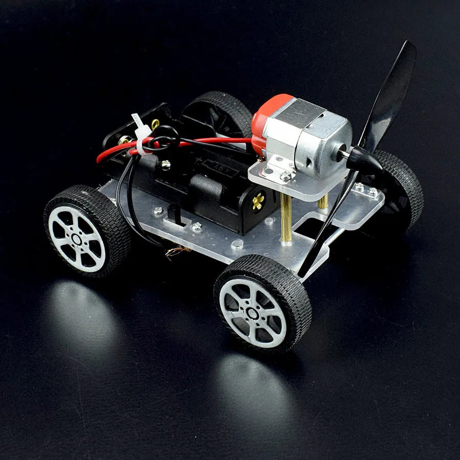 Wind Car DIY Electronic Science Kit with acrylic plastic chassis, dimensions 7.7cm by 10cm.