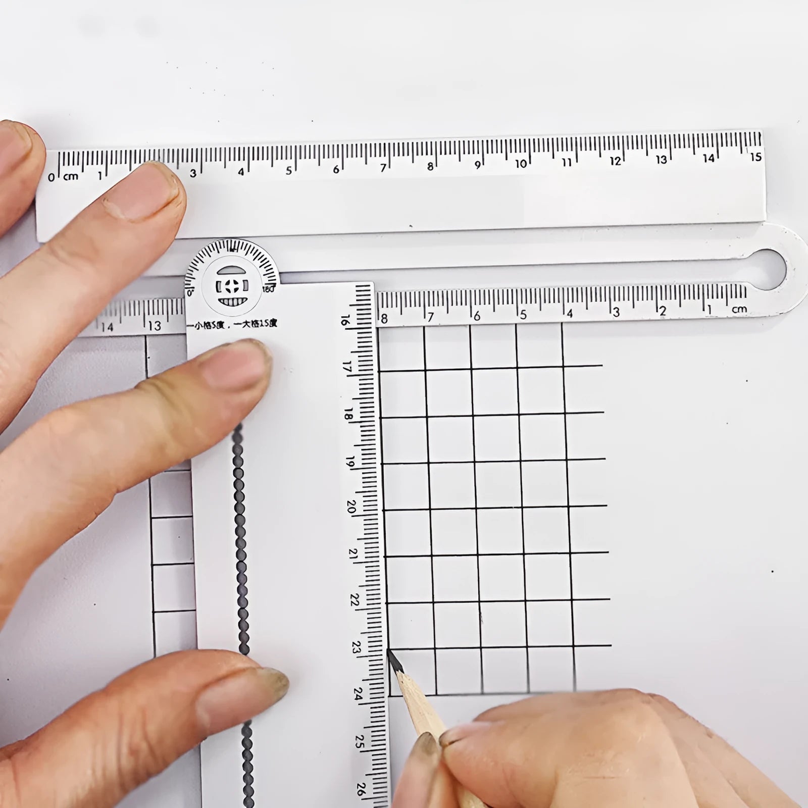 White plastic multi-function angle ruler showing measurement markings and 30cm length