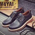 Men's black casual shoes with round toe, flat heel, and front-tie laces on a rubber sole.