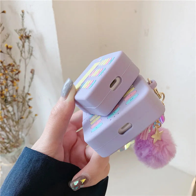 Purple silicone protective case for Apple AirPods with attached white fur ball pendant