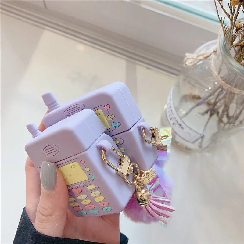 Purple silicone protective case for Apple AirPods with attached white fur ball pendant