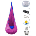 Green cotton pod swing chair hanging outdoors with inflatable cushion