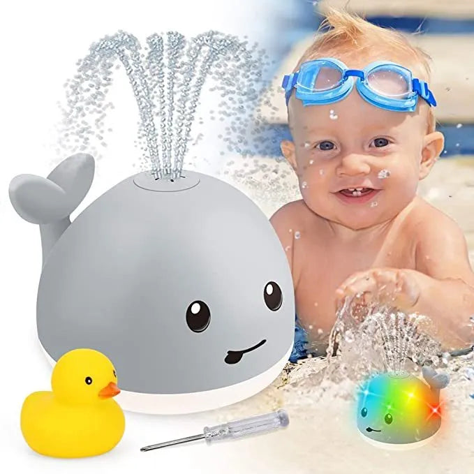 Grey and white whale bath toy with water spray, LED lights, and automatic water-sensing activation