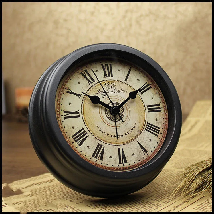 Round European style retro desk clock with silent alarm on a wooden surface.