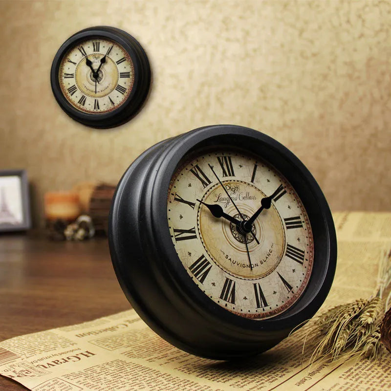 Round European style retro desk clock with silent alarm on a wooden surface.