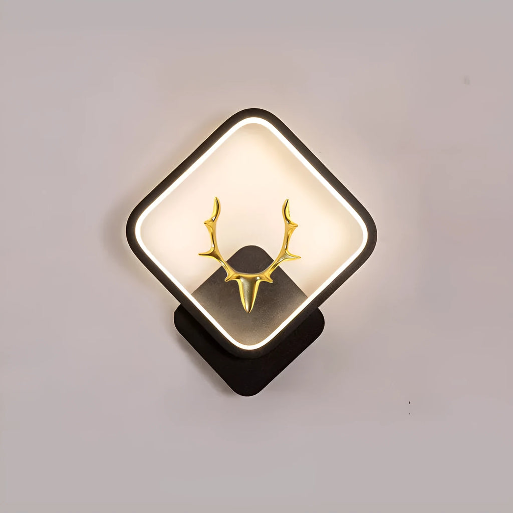 Deer antler shaped wall lamp with remote control on a light-coloured wall.