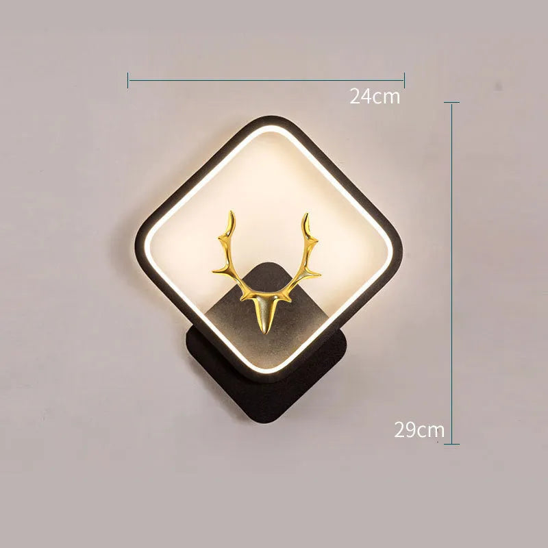 Deer antler shaped wall lamp with remote control on a light-coloured wall.