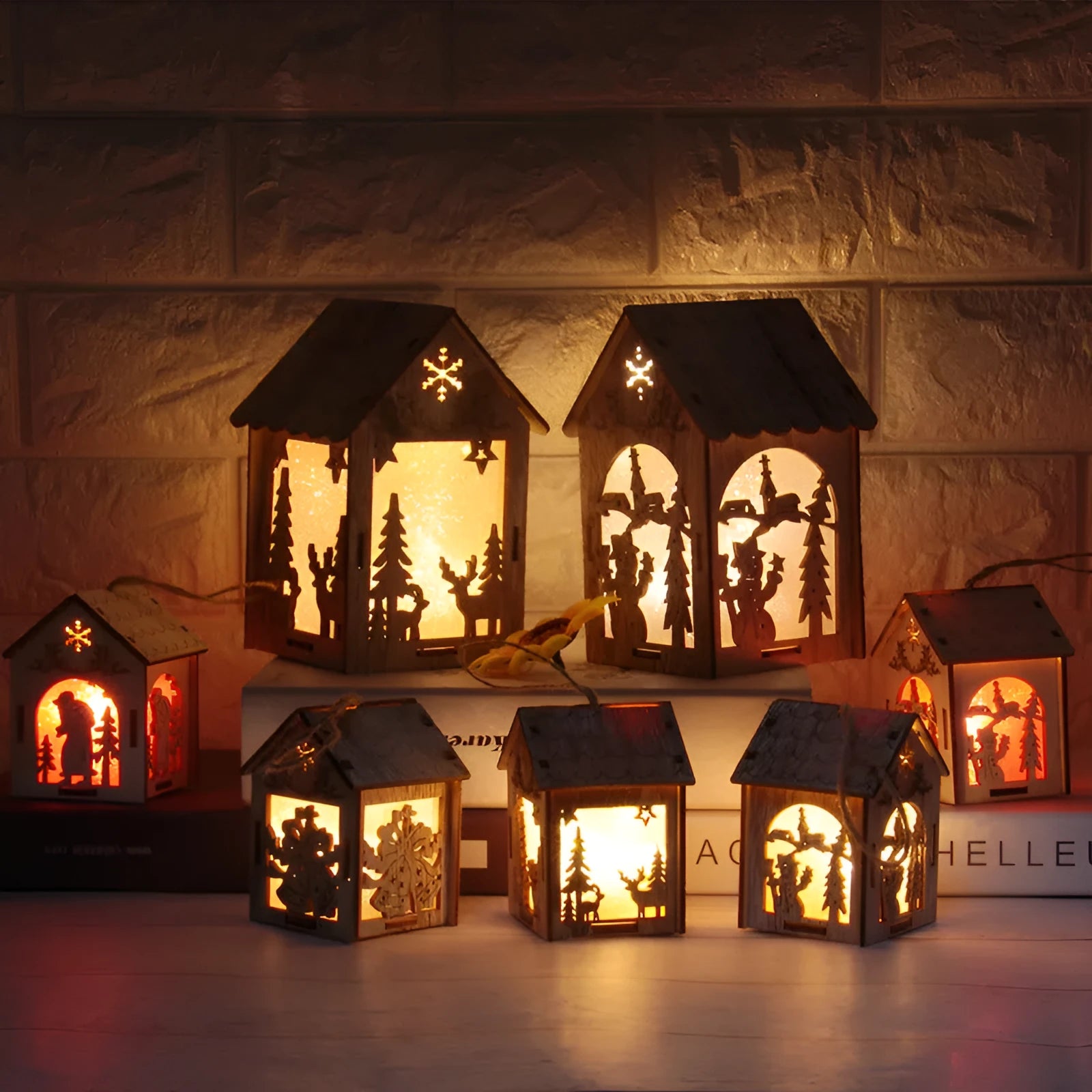 Three wooden Christmas ornaments: small log bell, wooden house with Santa, wooden house with snowman in natural wood colour
