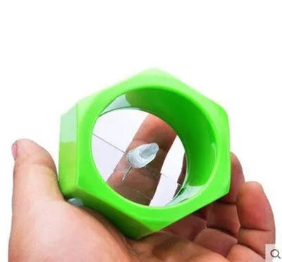 Yellow and green spiral vegetable cutter kitchen gadget for slicing cucumbers.
