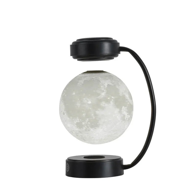 Black and gold magnetic levitation moon lamp with three-colour light changing on bedside table