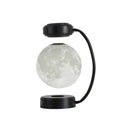 Black and gold magnetic levitation moon lamp with three-colour light changing on bedside table
