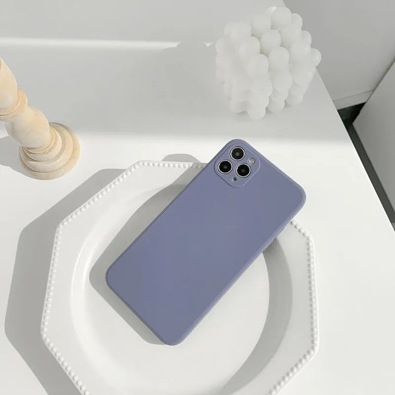 Slim solid colour silicone TPU case for iPhone on a table.